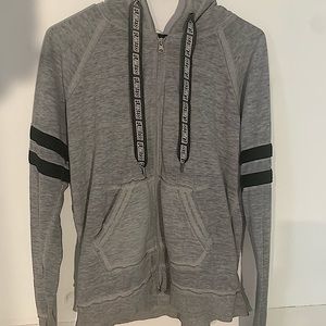 Grey hoodie with 2 black stripes on each sleeve.